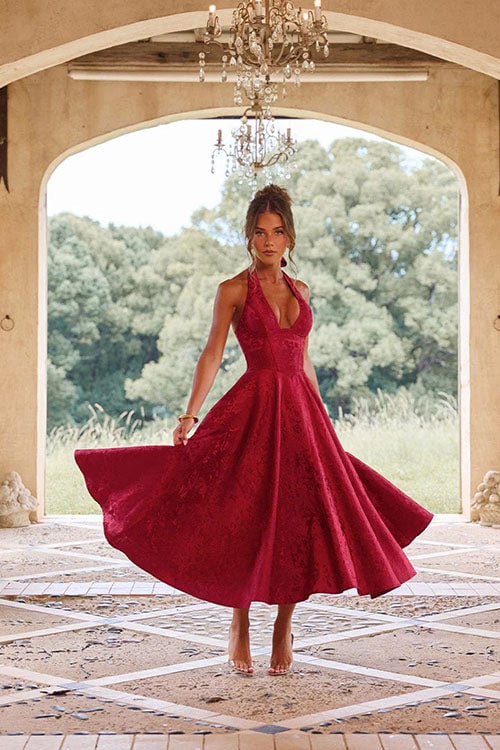 Wine red halterneck jacquard maxi dress styled for a formal dinner occasion