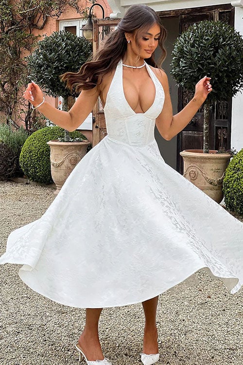 White jacquard maxi dress with halterneck cut showing fabric texture and fit