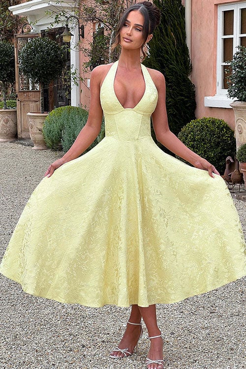 Yellow V-neck jacquard maxi dress with a flared skirt on a model at a party