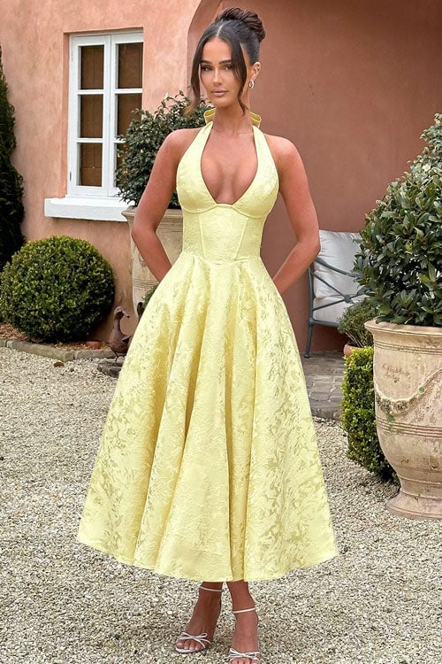 Model wearing a pink V-neck jacquard maxi dress with a flowing flared skirt