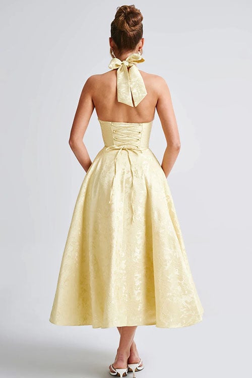 White sleeveless halterneck maxi dress in jacquard fabric on a model
