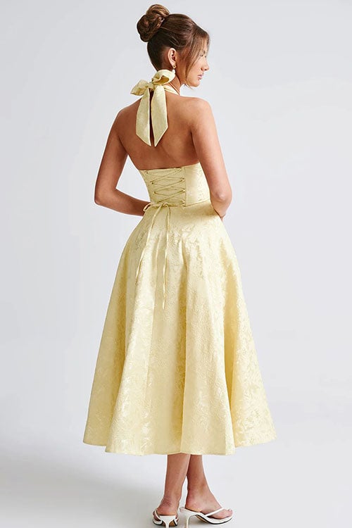 White V-neck halterneck jacquard maxi dress on a model at an outdoor celebration