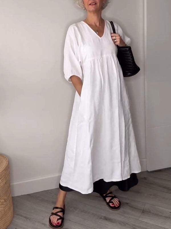 Full-length front view of a white tummy control midi dress styled with sandals