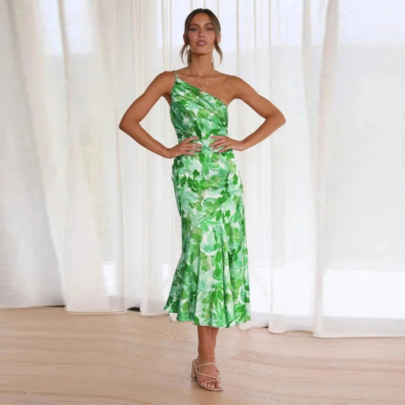 Woman in the Genevieve blue floral asymmetric midi dress at an outdoor gathering