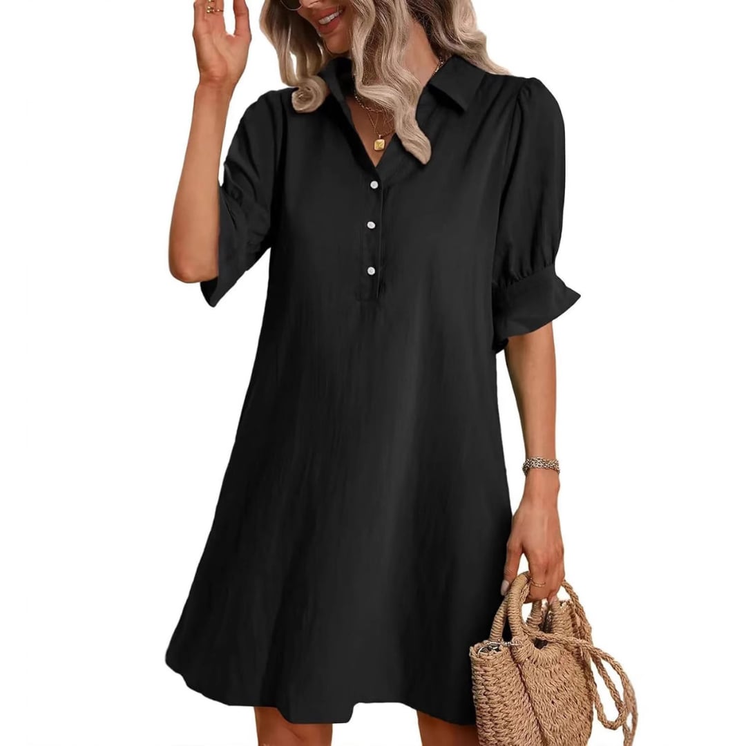 Woman wearing a black button-down shirt dress with a flattering silhouette, shown from the front