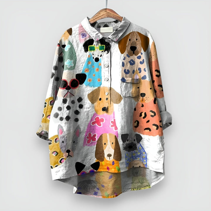 Close-up of the whimsical dog print detail on a women's relaxed-fit shirt in white