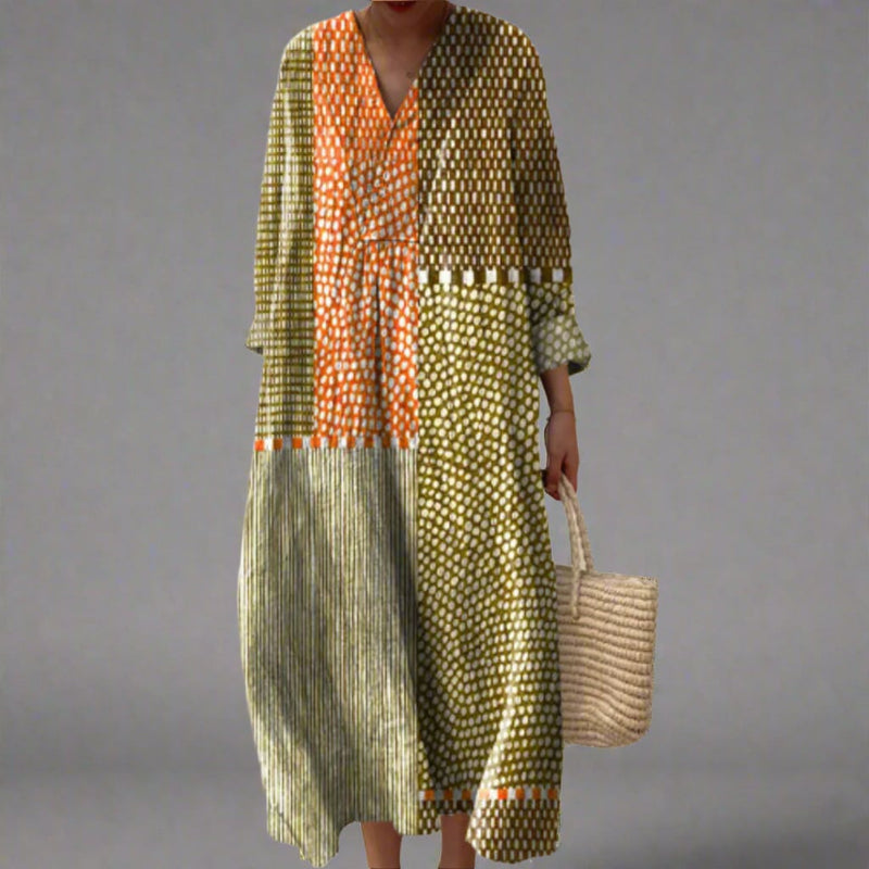 Model wearing the Gia elegant geometric print dress in a flowing silhouette with a bold all-over pattern