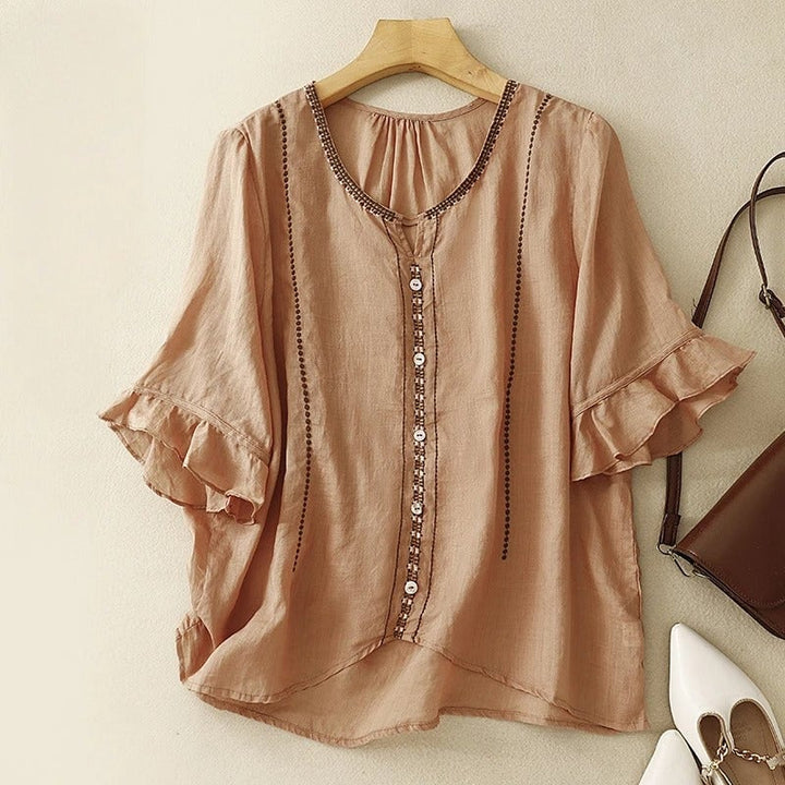Flat lay of the pattern ruffle sleeve blouse in brown showing embroidery and button front detail