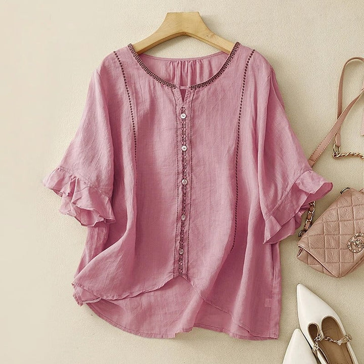Model wearing pink ruffle sleeve blouse in a casual outdoor setting