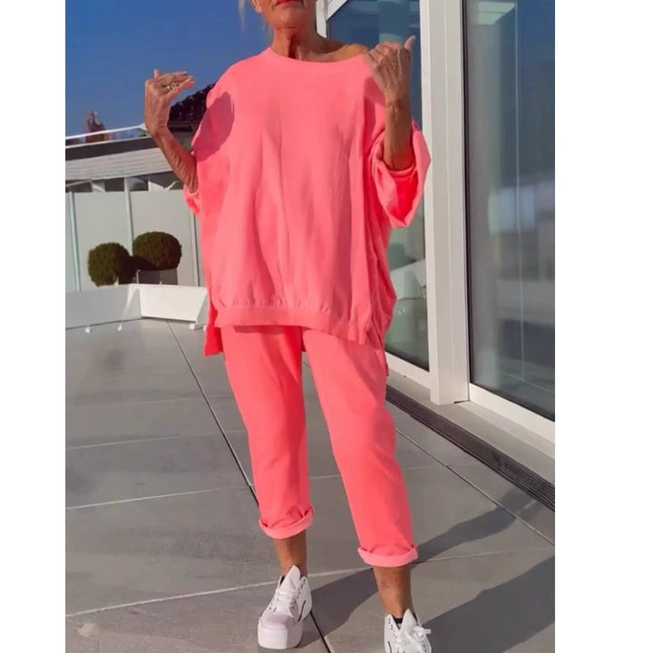 Woman wearing a soft coordinated two-piece lounge set in pink with a relaxed fit top and matching bottoms
