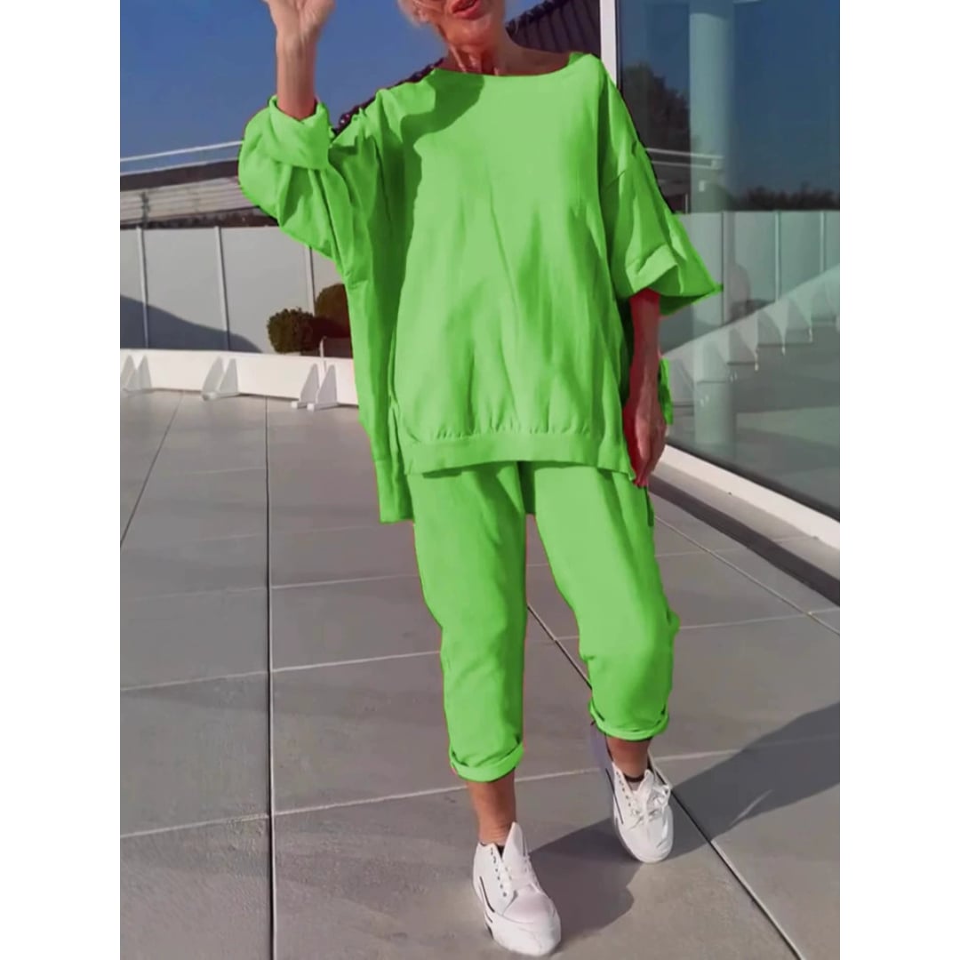 Woman wearing the Gilda two-piece lounge set in light green showing the relaxed trouser length