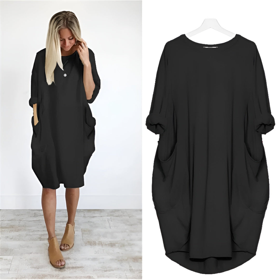 Model wearing the Gina elegant pocket dress in a flowing silhouette with a subtle side slit