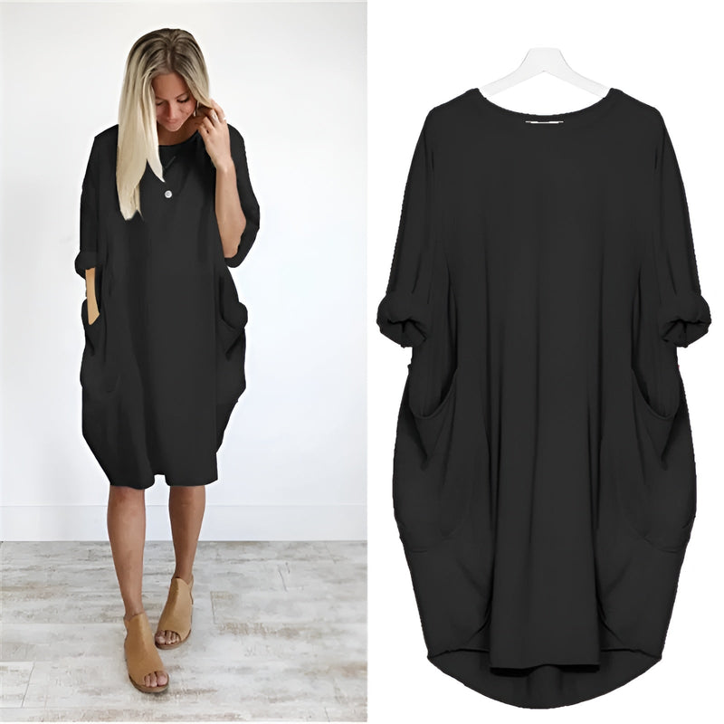 Model wearing the Gina elegant pocket dress in a flowing silhouette with a subtle side slit