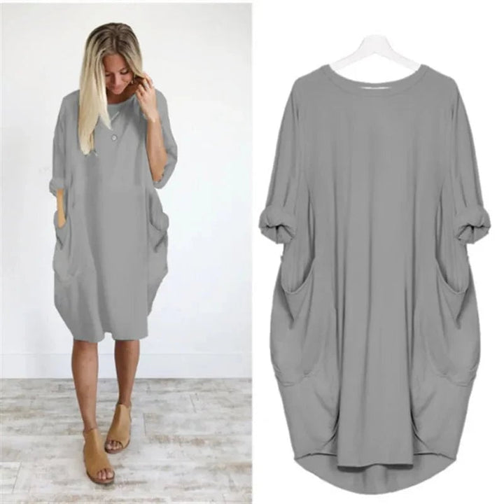 Front view of the Gina dress in a light, airy color showing the elegant drape and neckline