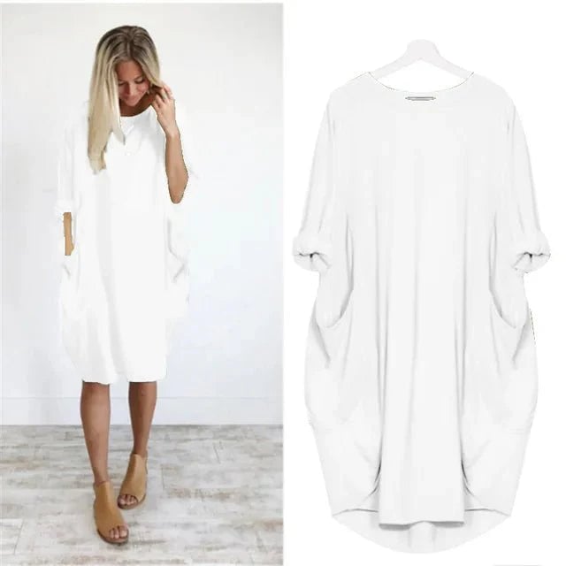 Model smiling in the Gina elegant pocket dress styled casually for daytime wear