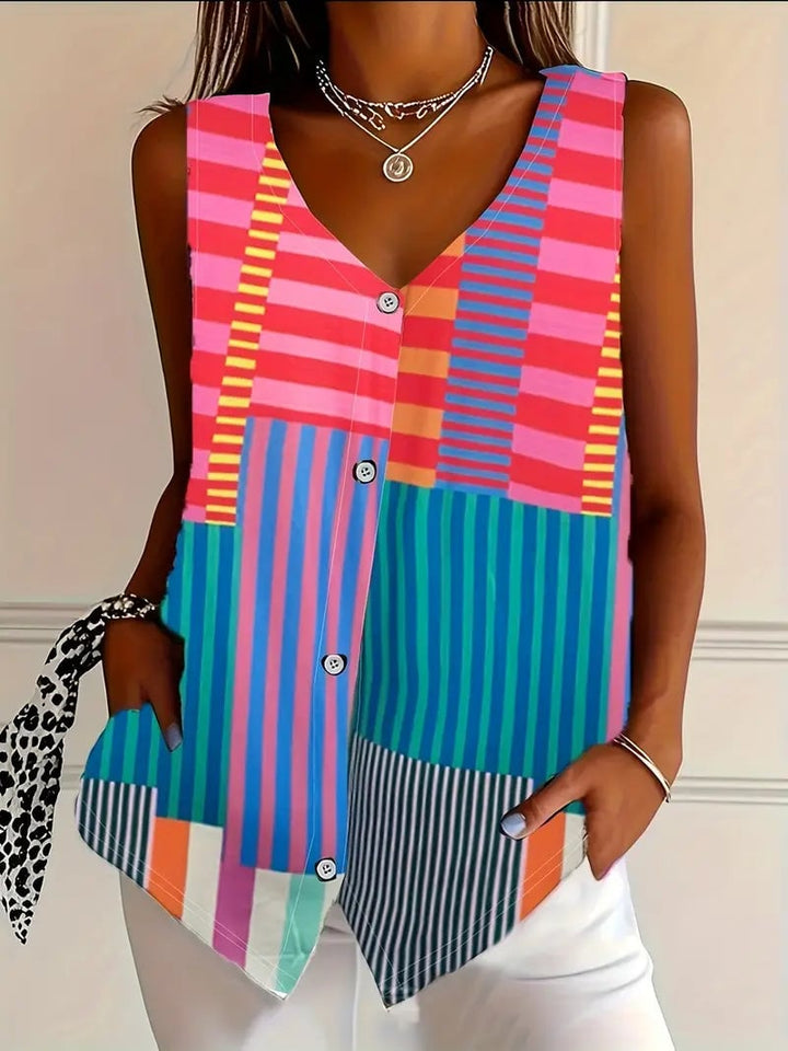 Model styling the Gina pattern blouse tucked into high-waist trousers for a polished everyday look