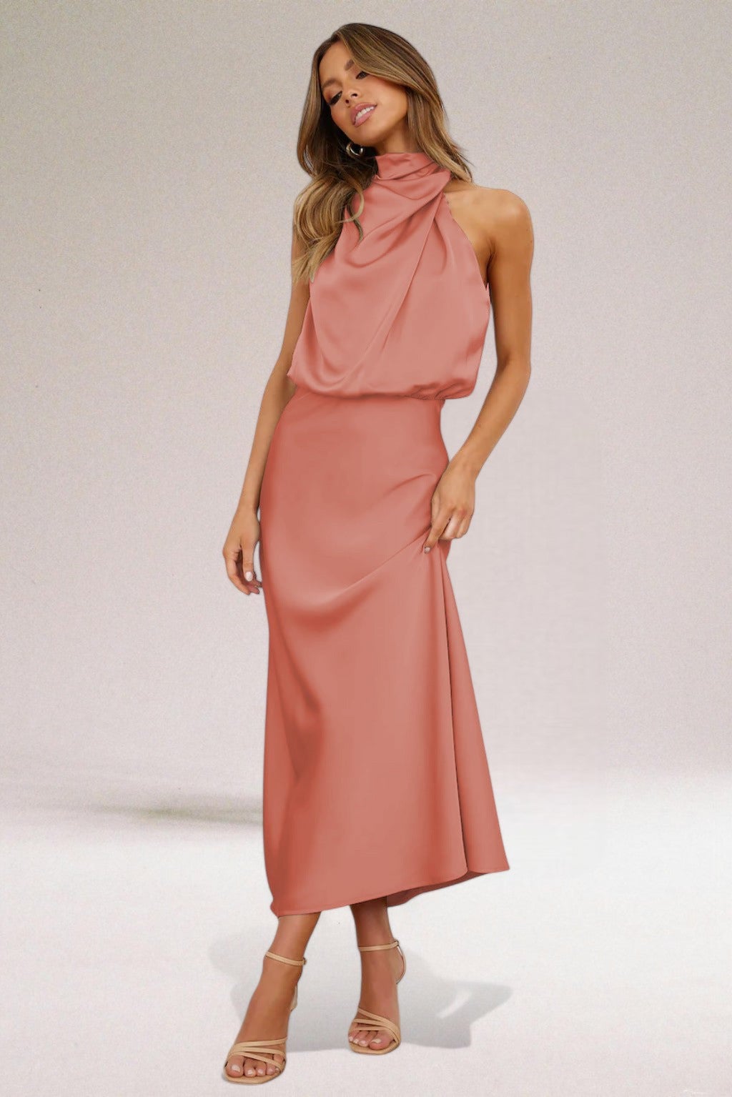 Model in a halter neck dress posing to show graceful movement and lightweight fabric drape