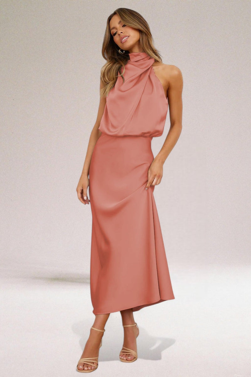 Model in a halter neck dress posing to show graceful movement and lightweight fabric drape