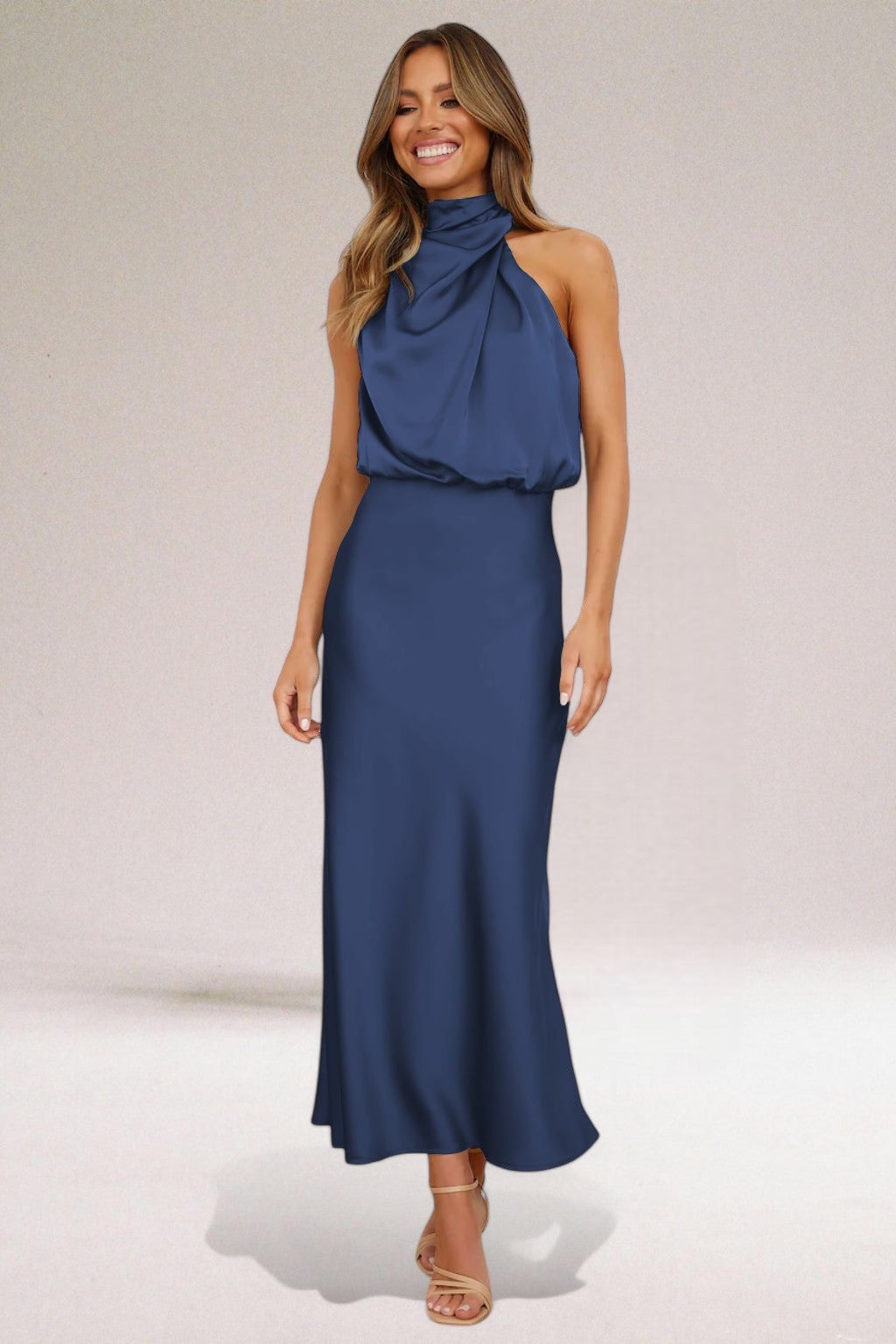 Full-length side view of the elegant halter neck dress highlighting the flowing silhouette