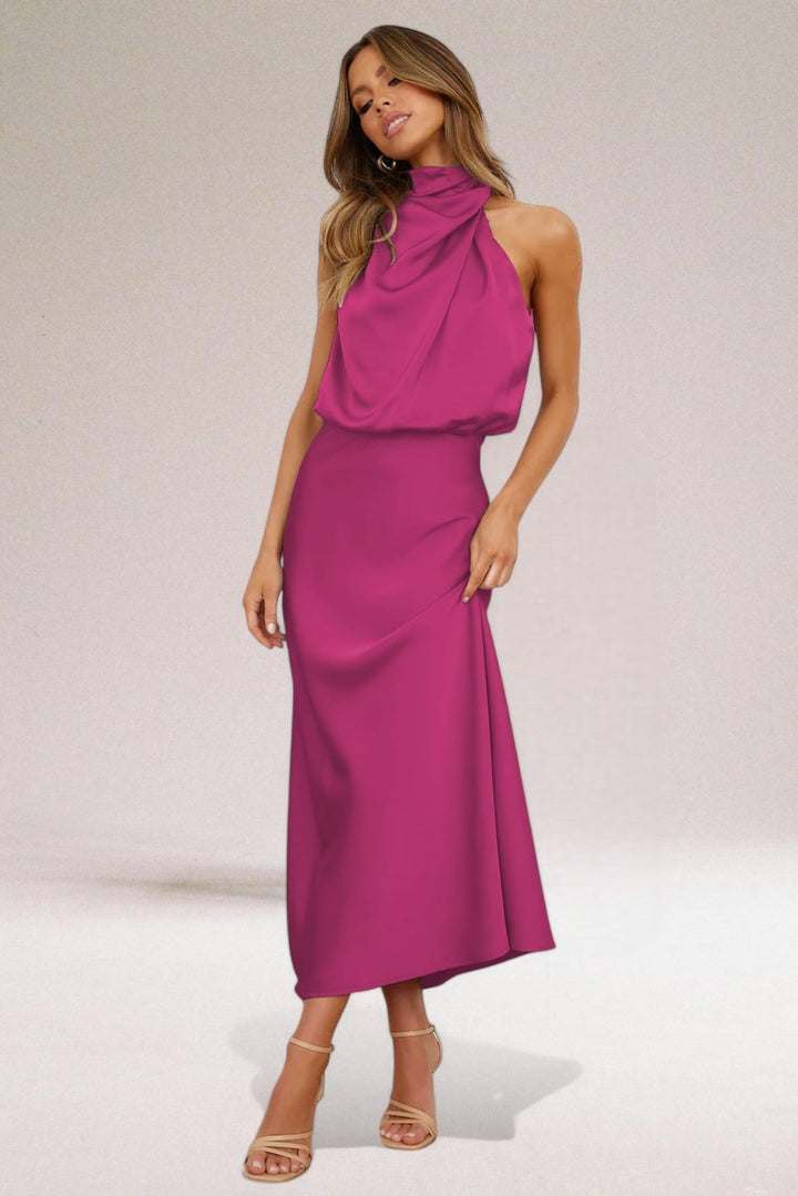 Woman in a halter neck dress styled for a formal event, showcasing color and fit