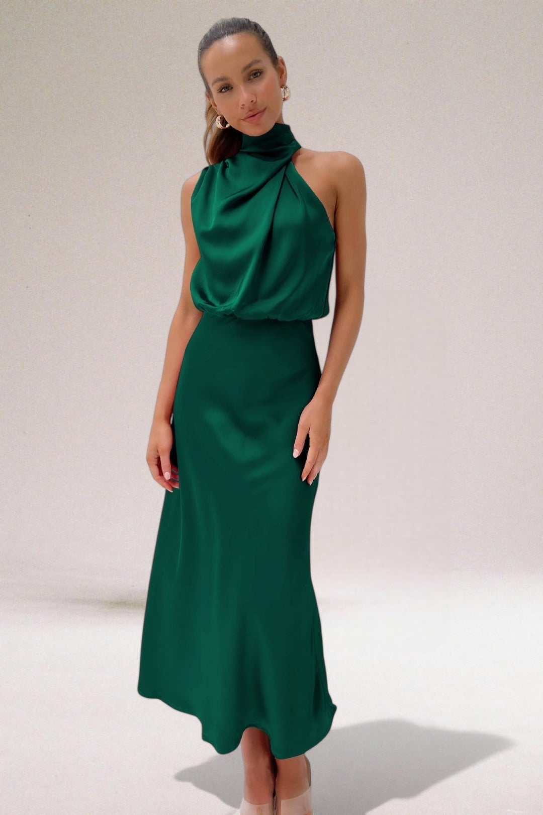 Detail shot of the luminous fabric texture and subtle sheen on the halter neck dress