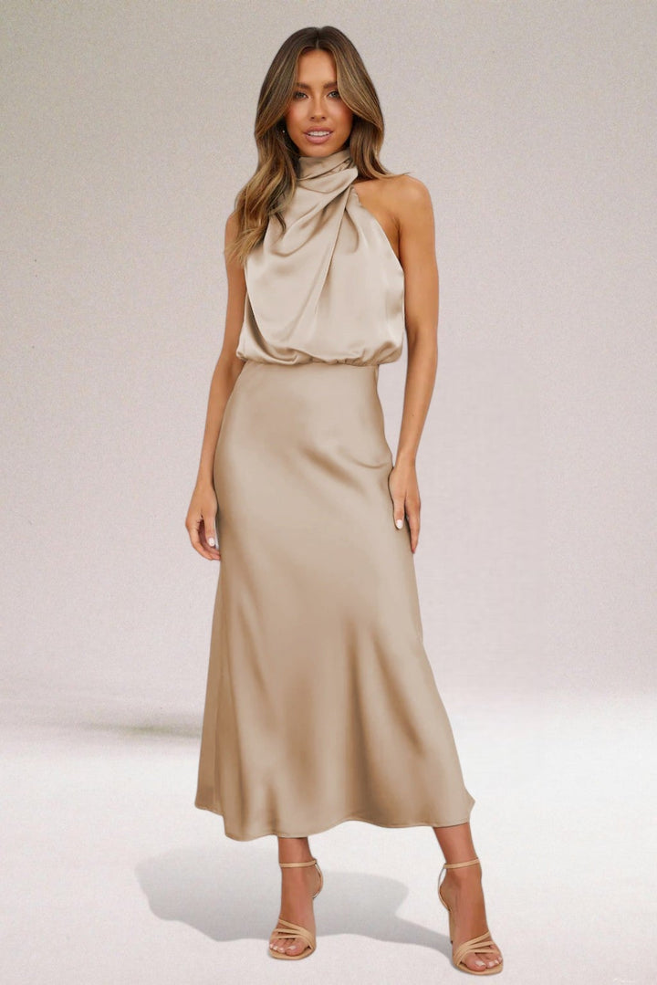 Model wearing the halter neck dress in an upscale setting, demonstrating versatile occasion styling