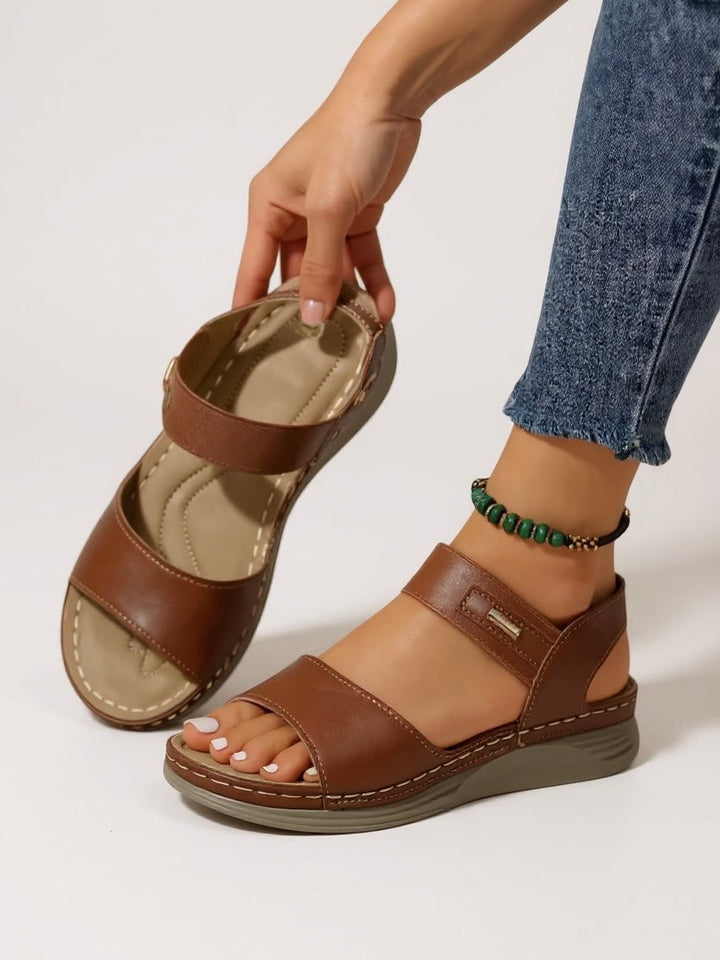 Giselle sandals in brown worn on feet, casual lifestyle setting