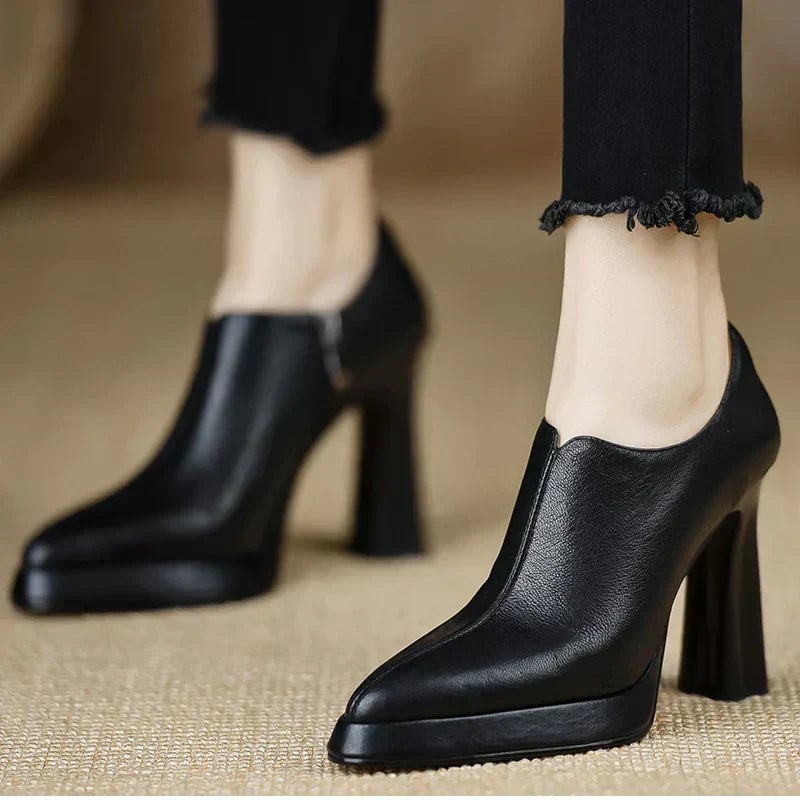 Pair of Giselle pumps in black and brown displayed side by side