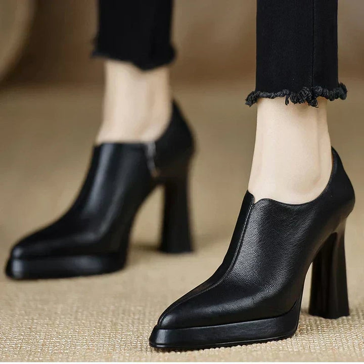 Pair of Giselle pumps in black and brown displayed side by side