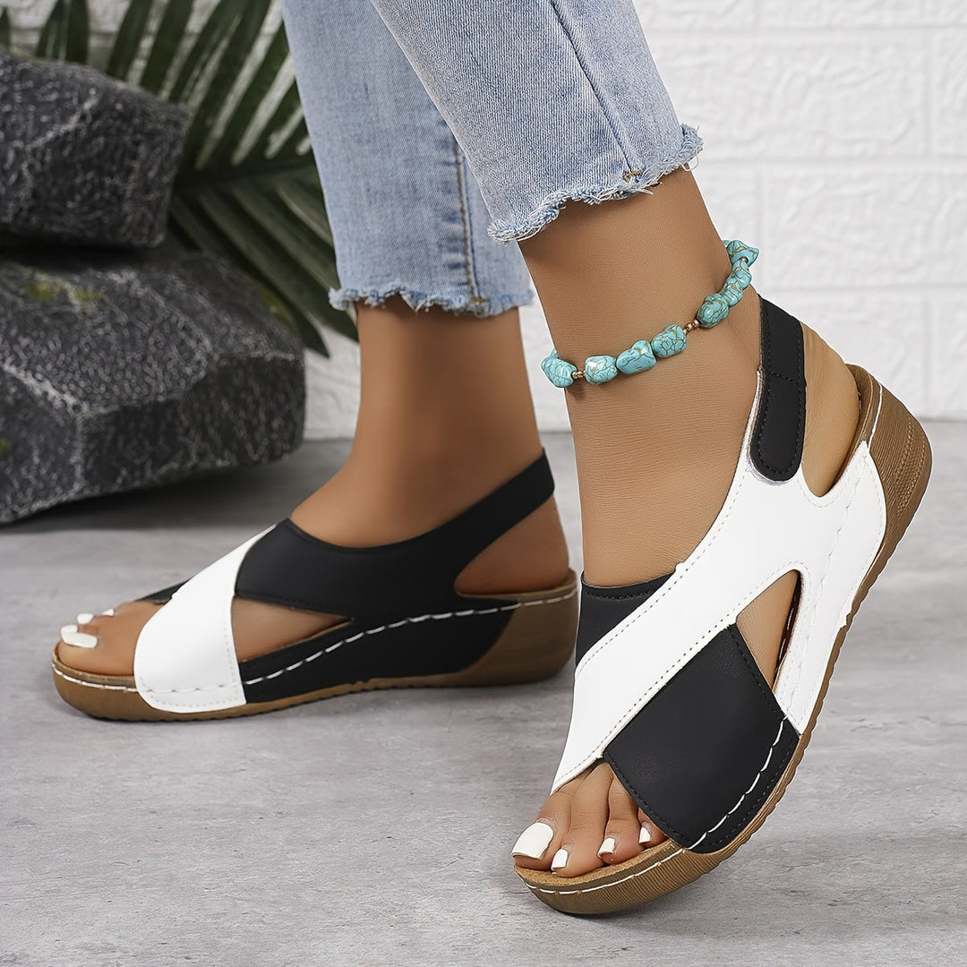 Woman wearing Gloria orthopedic sandals in blue while walking outdoors on a sunny day