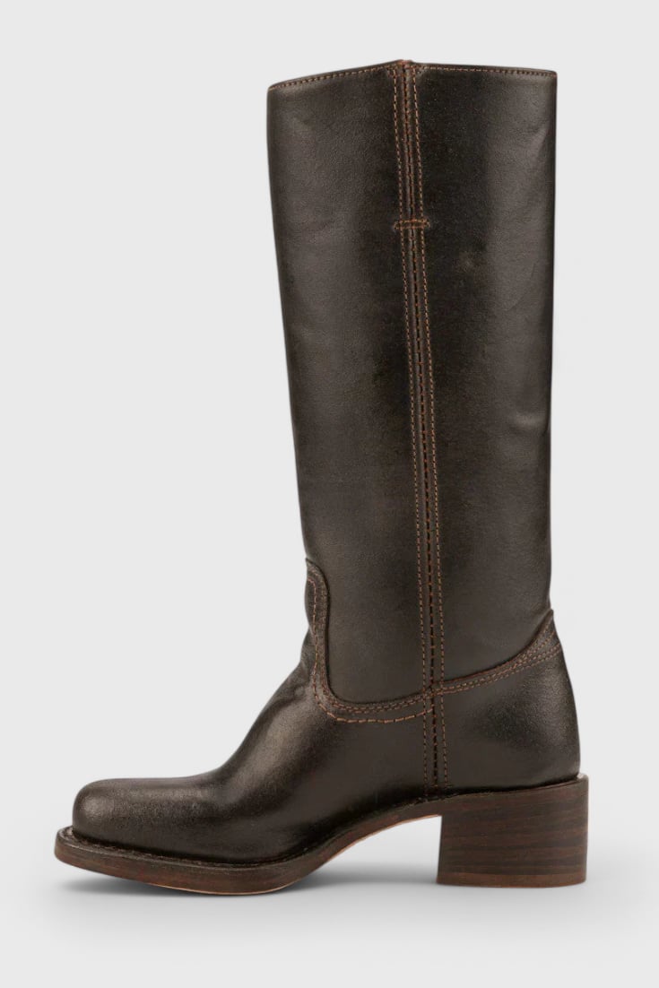 Grace boots in black shown on a model walking, highlighting all-season wearability
