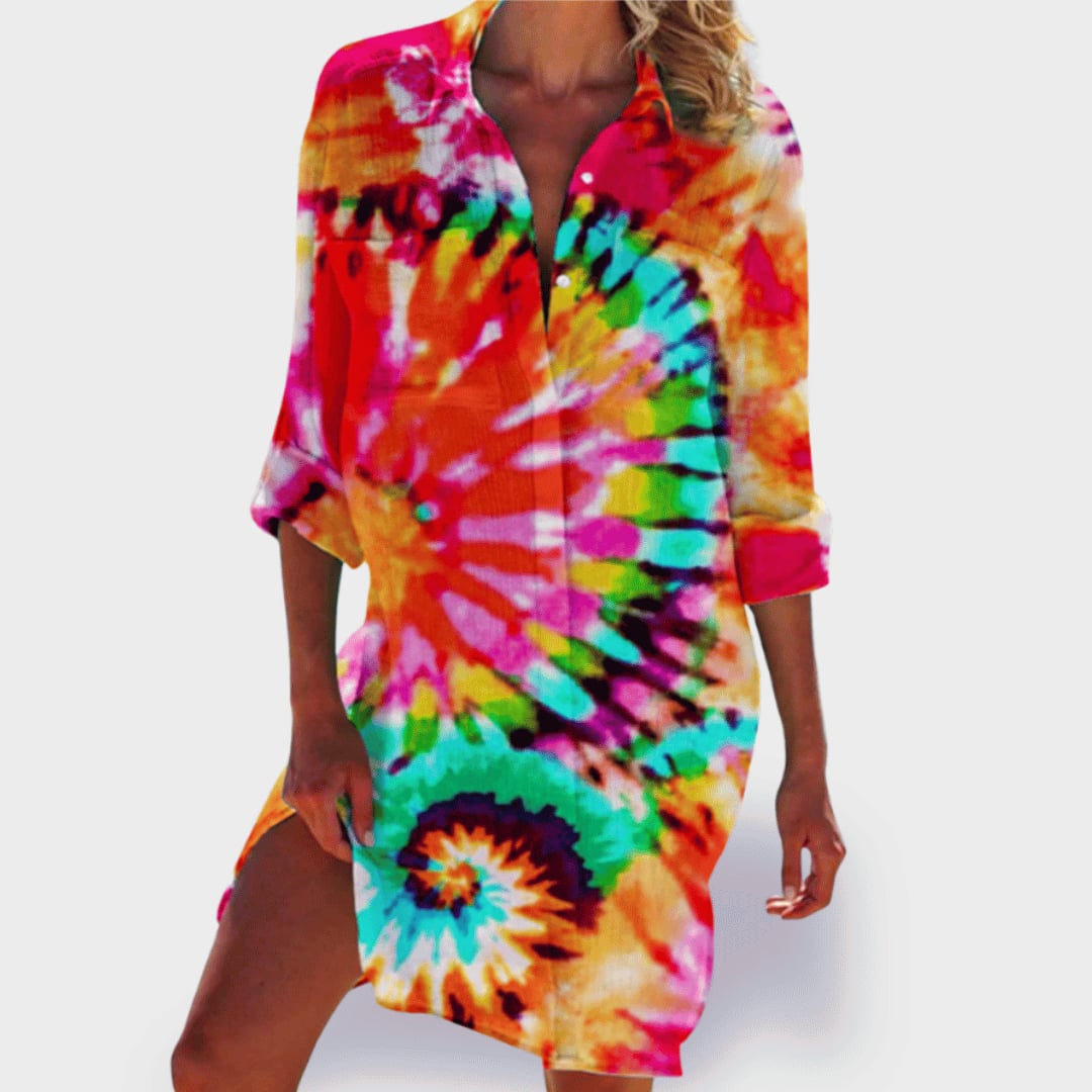 Woman wearing the Grace flowy colorful draped summer dress in a vibrant orange hue