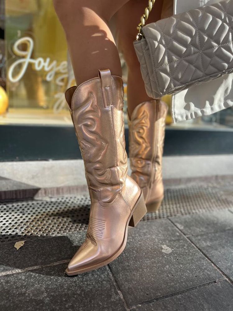 Pair of silver metallic cowboy boots styled with denim jeans