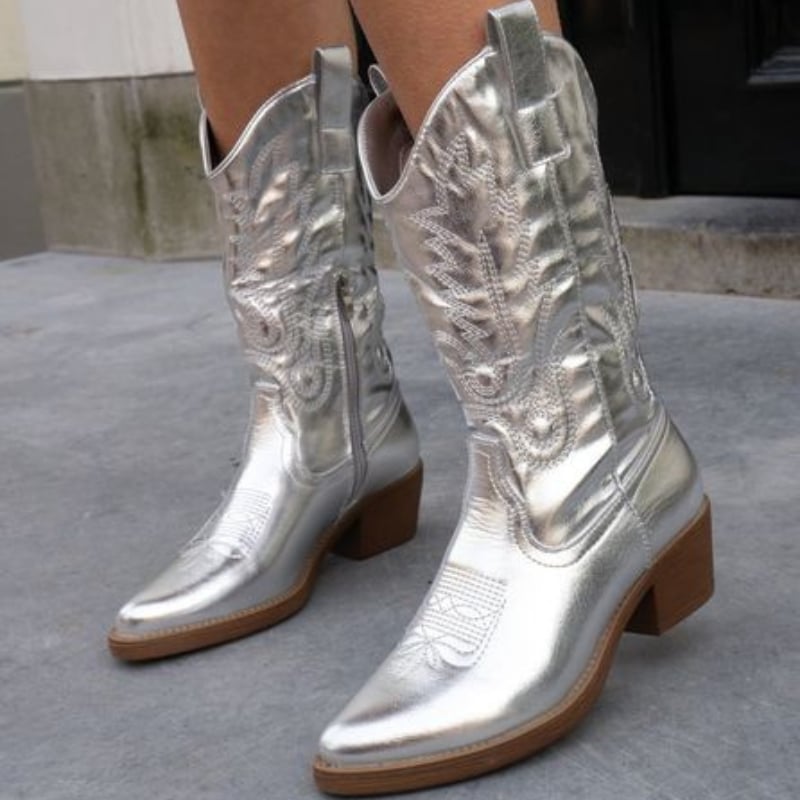 Model wearing gold metallic cowboy boots with a floral dress, full-length lifestyle shot