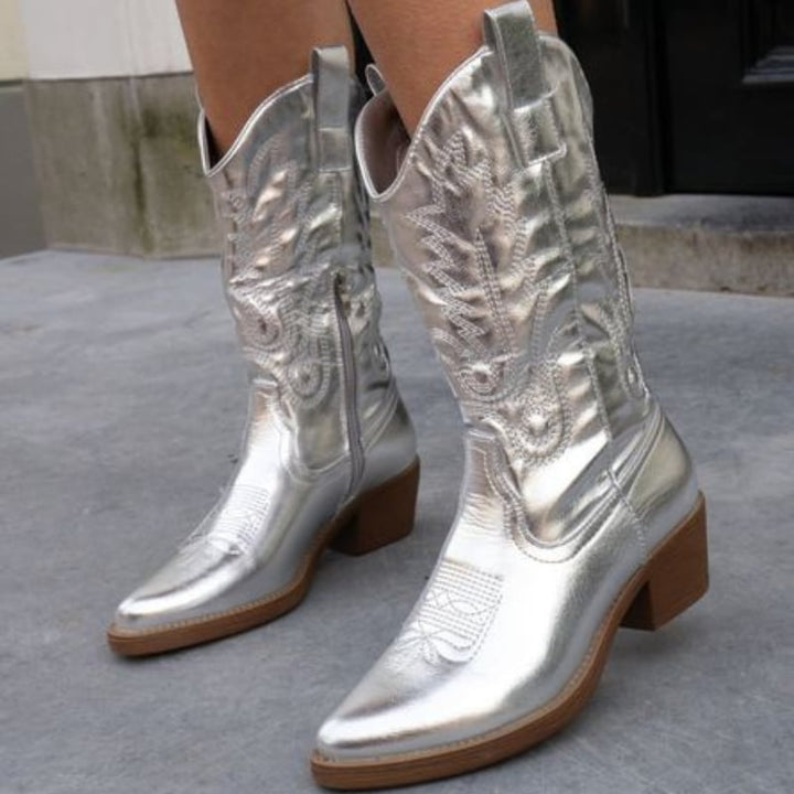 Model wearing gold metallic cowboy boots with a floral dress, full-length lifestyle shot