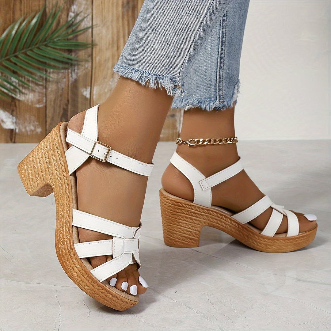 Flat lay of all five Greta wedge sandal colors: black, white, yellow, sea blue, dark brown