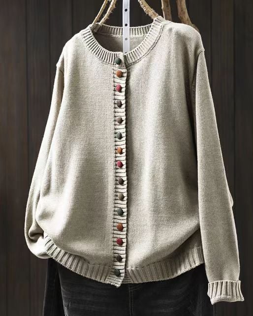 Woman in a brown cardigan layered over a blouse, styled for a polished daytime look