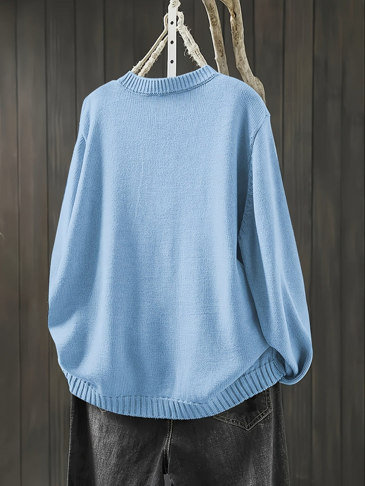 Side profile of a woman in a light blue cardigan showing relaxed fit and sleeve length