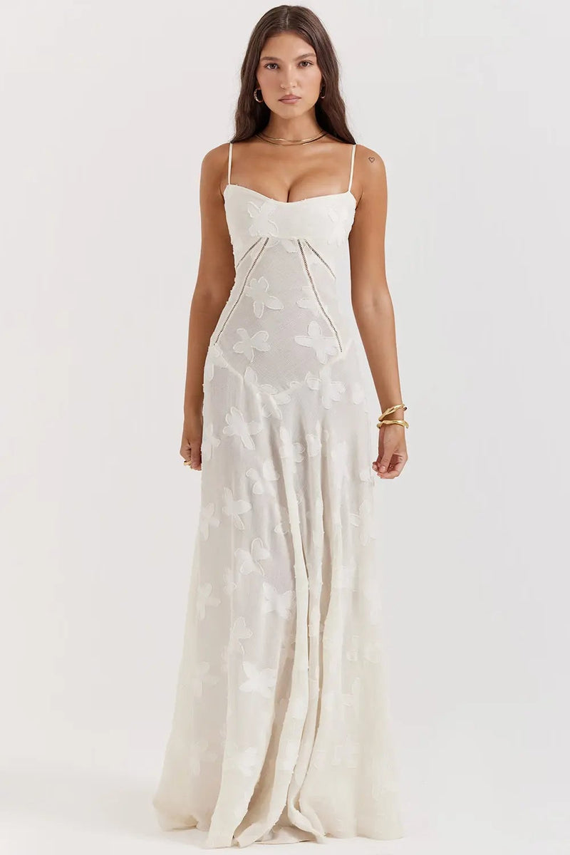 Close-up of the open back detail on a long flowy summer dress with adjustable spaghetti straps in white
