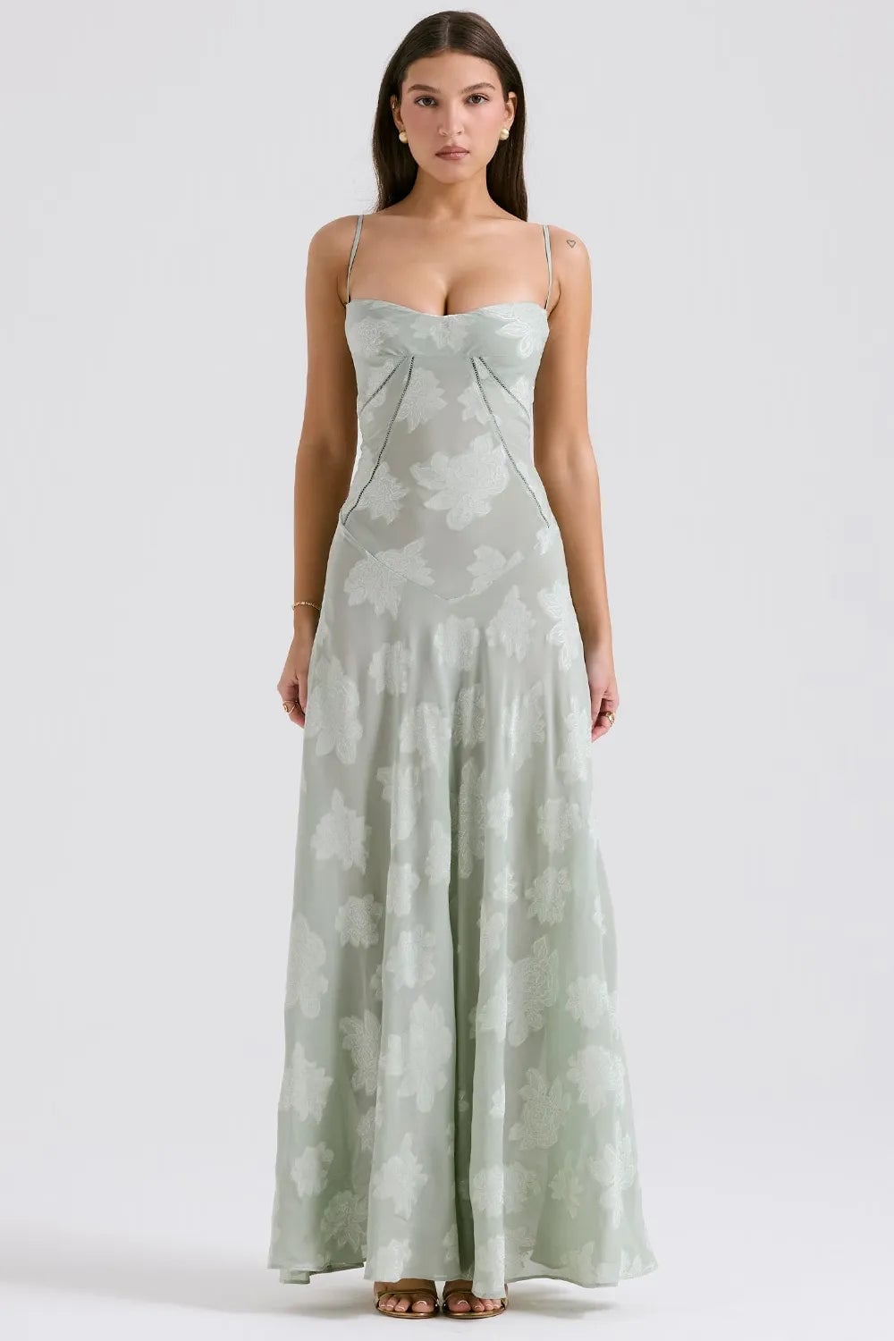 Model in a long green summer maxi dress with adjustable straps, relaxed flowing fit, outdoor setting