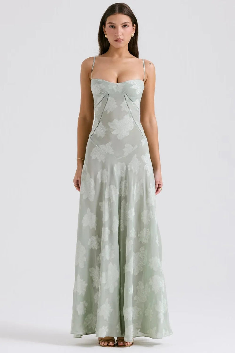 Model in a long green summer maxi dress with adjustable straps, relaxed flowing fit, outdoor setting