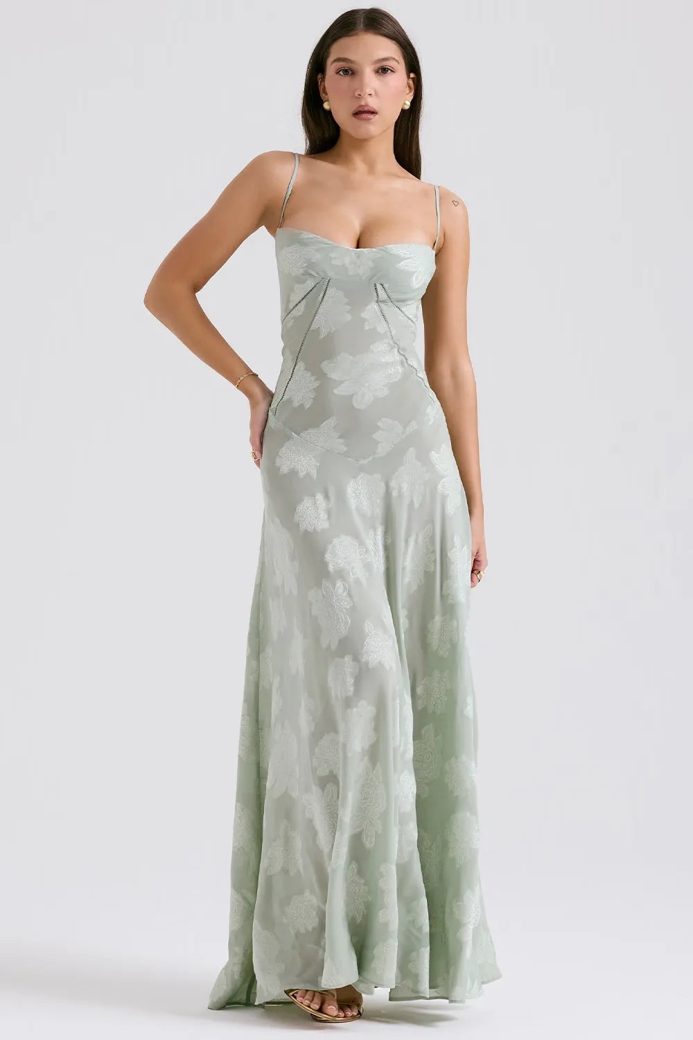 Side profile of a long pink summer dress highlighting the open back and draped bodice