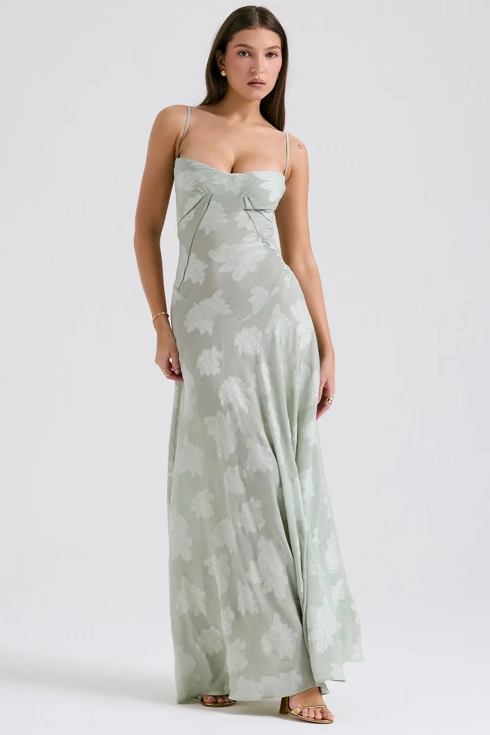 Model in a long green open-back dress with adjustable spaghetti straps, relaxed summer style