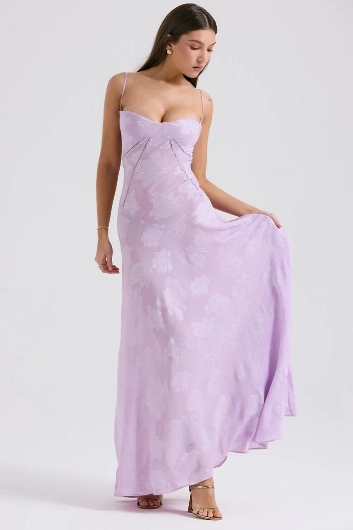Full-body view of a long purple summer dress with open back, showing the hem sweep
