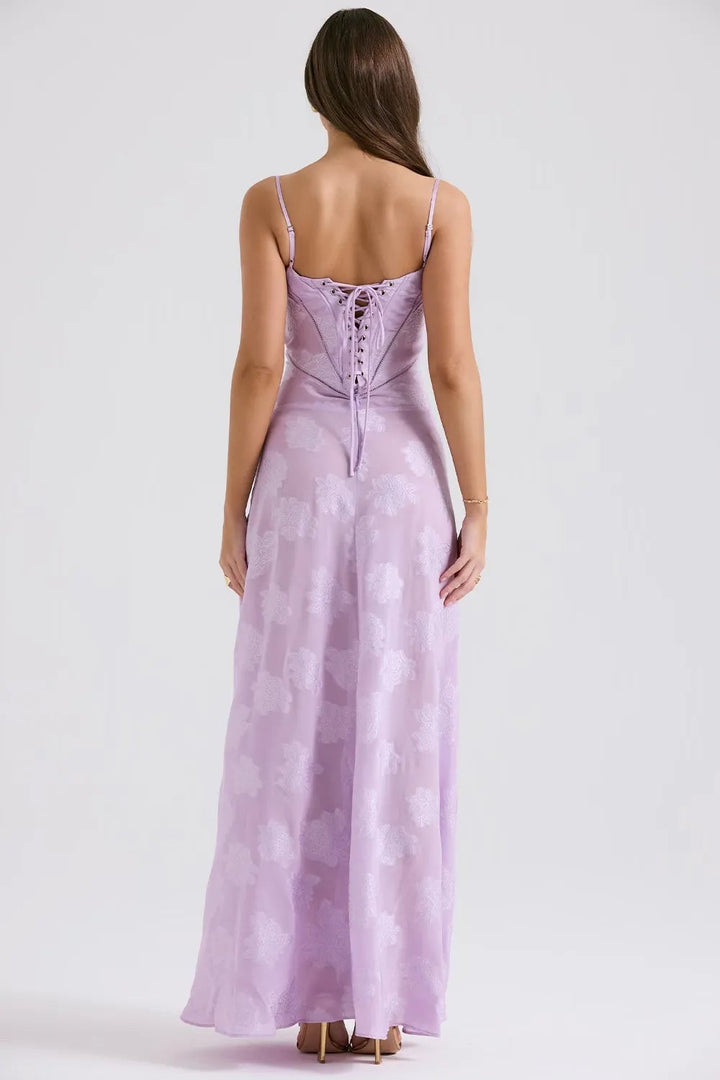 Side view of a long pink summer dress with adjustable straps, graceful movement captured