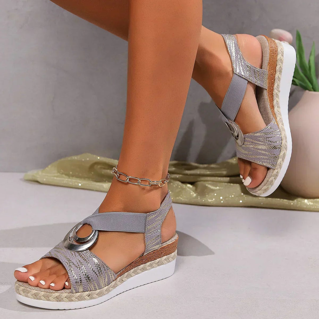 Model wearing Grove white orthopedic sandals on a light wood floor