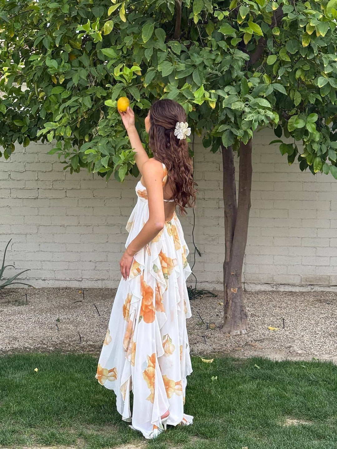 Full-length view of a layered halter maxi dress showing graceful movement and silhouette
