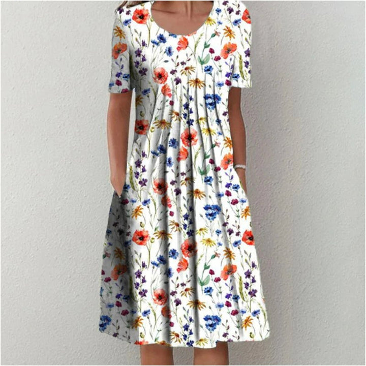 Woman wearing a vibrant red floral midi dress with pockets, styled casually for everyday wear