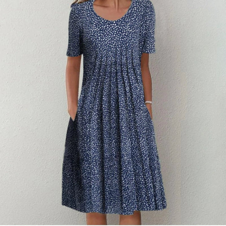 Side view of the blue floral dress highlighting the convenient side pocket detail