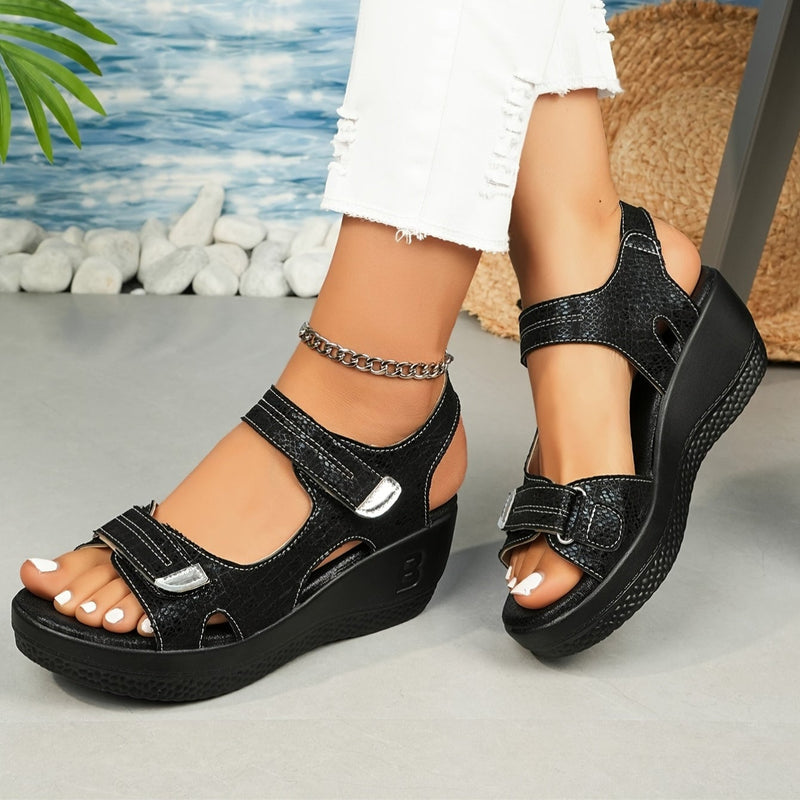 Hadley women's adjustable wedge sandals in black, front three-quarter view showing straps and wedge heel